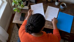 Consumer checking a debt summons at home