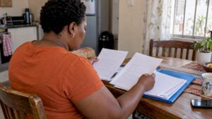Consumer reviewing debt review clearance paperwork